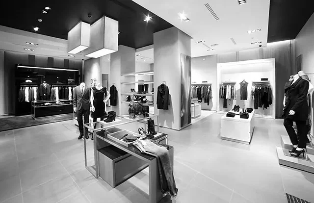 Clothing boutique interior with garment racks, mannequins and display tables