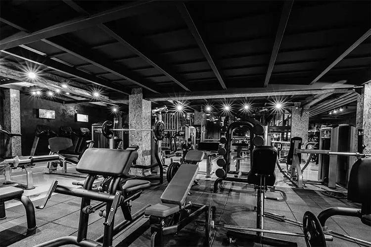 Fitness center weight room with machines and free weights