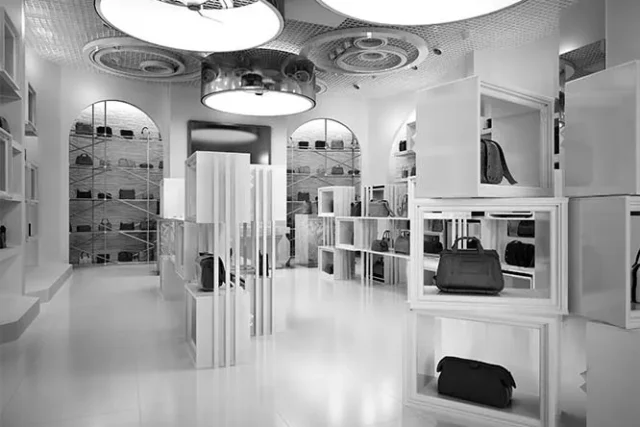 Accessories boutique with white display shelving and pendant lighting